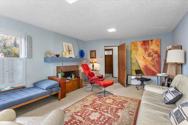 a bedroom with furniture and a large window