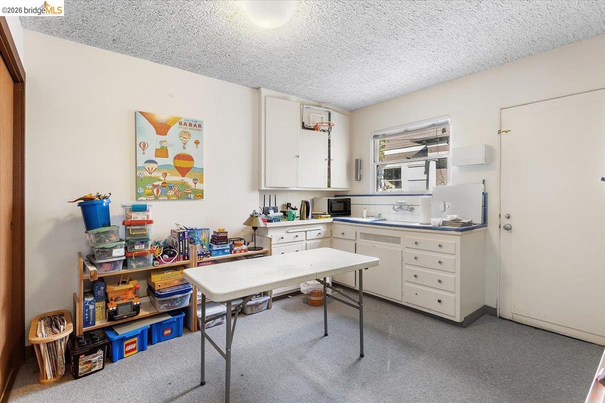 2702 Dana Street Berkeley, CA 94705 - Photo 14 of 37 a room with cabinets a table and chairs in it