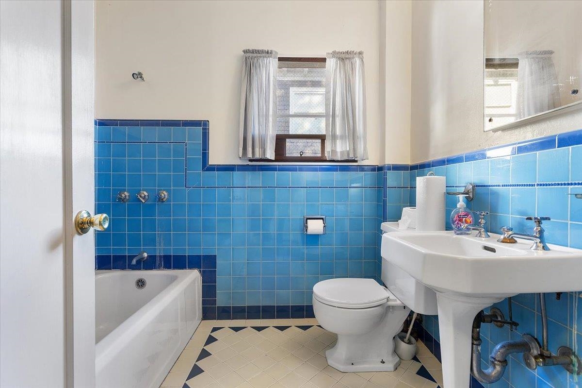 2702 Dana Street Berkeley, CA 94705 - Photo 15 of 37 Full bath with tile patterned floors, wainscoting, a bath, and tile walls