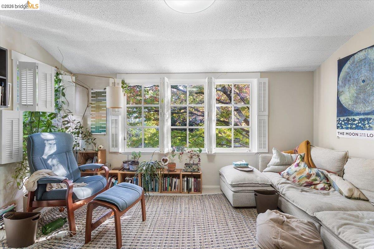 2702 Dana Street Berkeley, CA 94705 - Photo 16 of 37 a living room with furniture and a large window