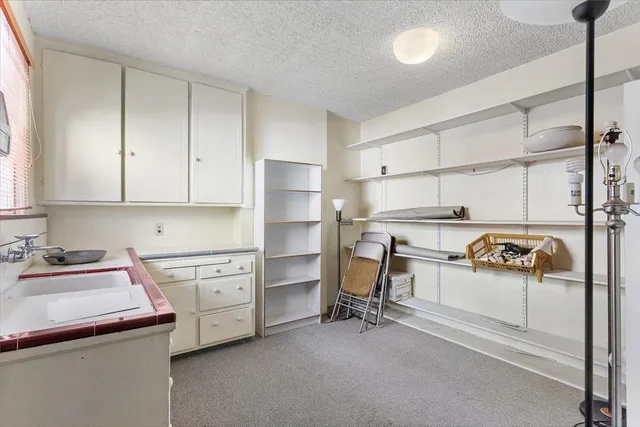 a kitchen with a stove a sink and a refrigerator