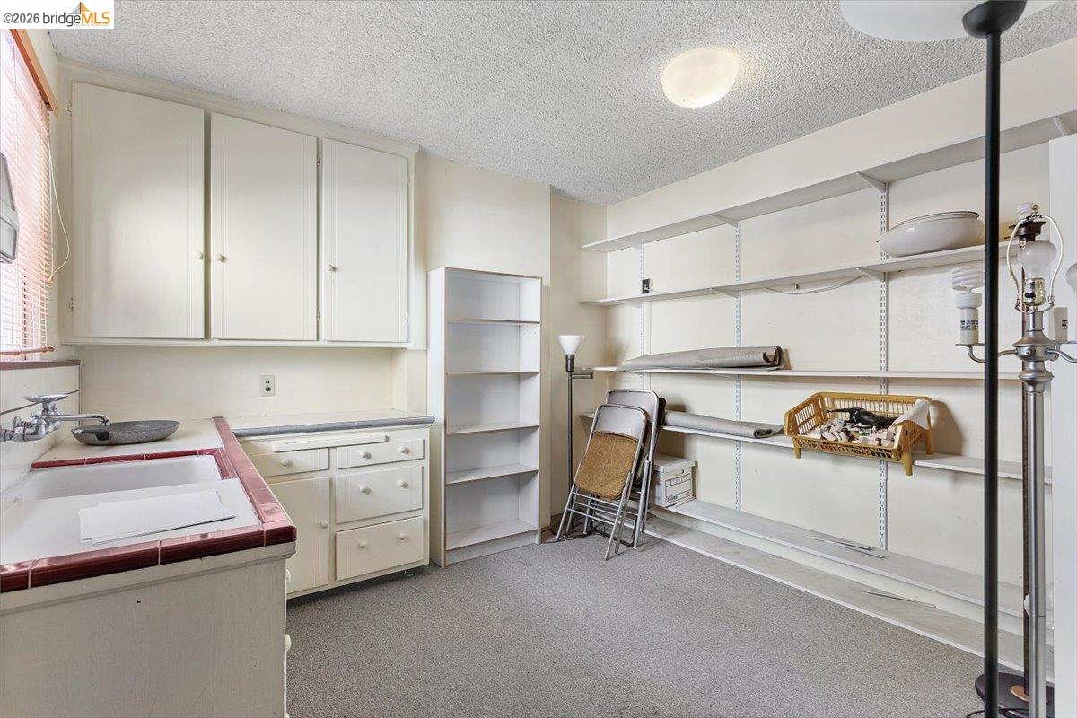 2702 Dana Street Berkeley, CA 94705 - Photo 18 of 37 a kitchen with a stove a sink and a refrigerator