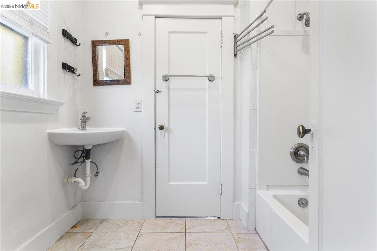 2702 Dana Street Berkeley, CA 94705 - Photo 30 of 37 a bathroom with a sink a mirror a bathtub and shower