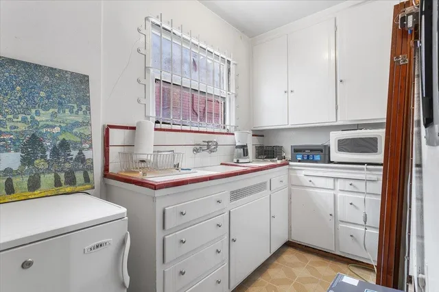 a kitchen with a sink stove and cabinets