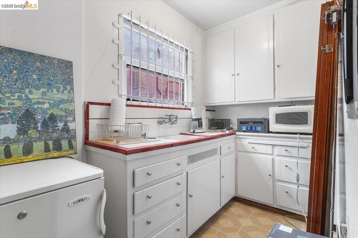 2702 Dana Street Berkeley, CA 94705 - Photo 8 of 37 a kitchen with a sink stove and cabinets