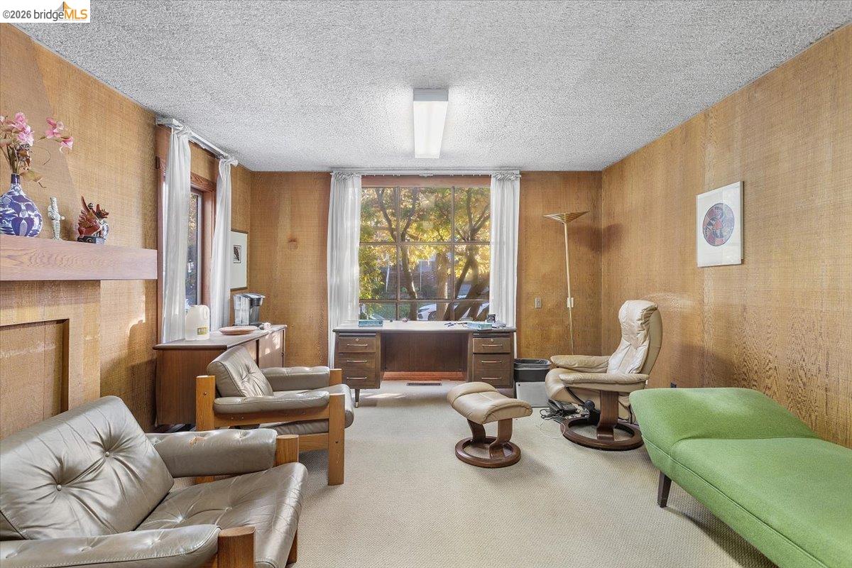 2702 Dana Street Berkeley, CA 94705 - Photo 9 of 37 a living room with furniture and a fireplace
