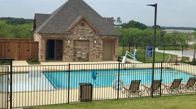 a view of a house with a fence