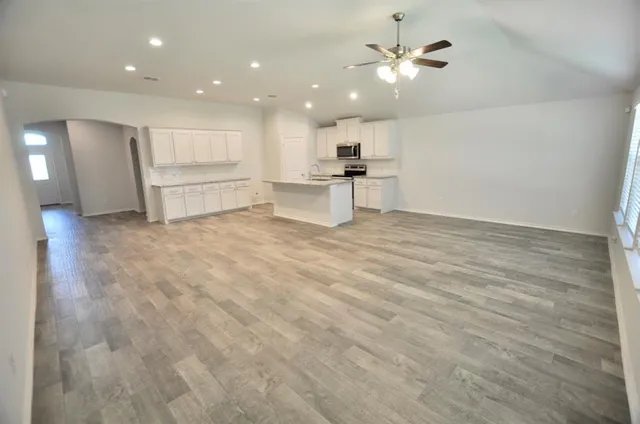 a view of kitchen with stove and cabinet
