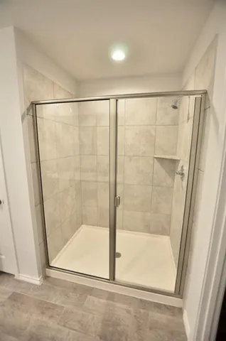 a bathroom with a glass shower door