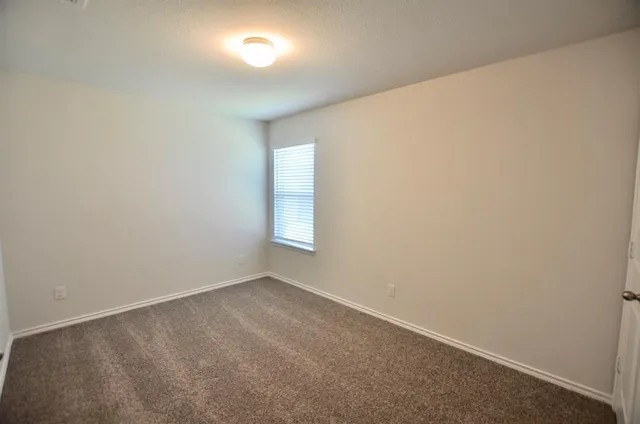 an empty room with a empty space and window