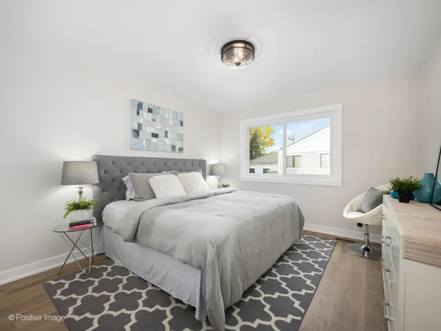 a bedroom with double bed and a window