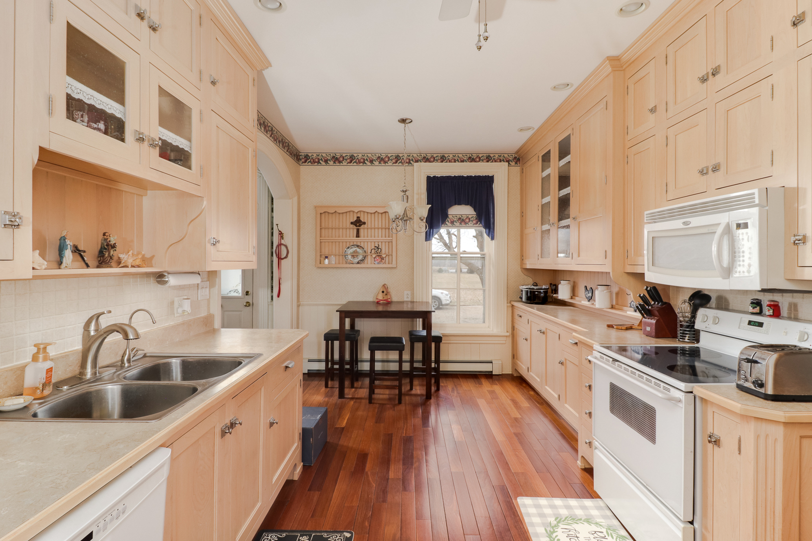 367 Horner Road Armington, IL 61721 - Photo 21 of 50 a kitchen with sink cabinets and wooden floor
