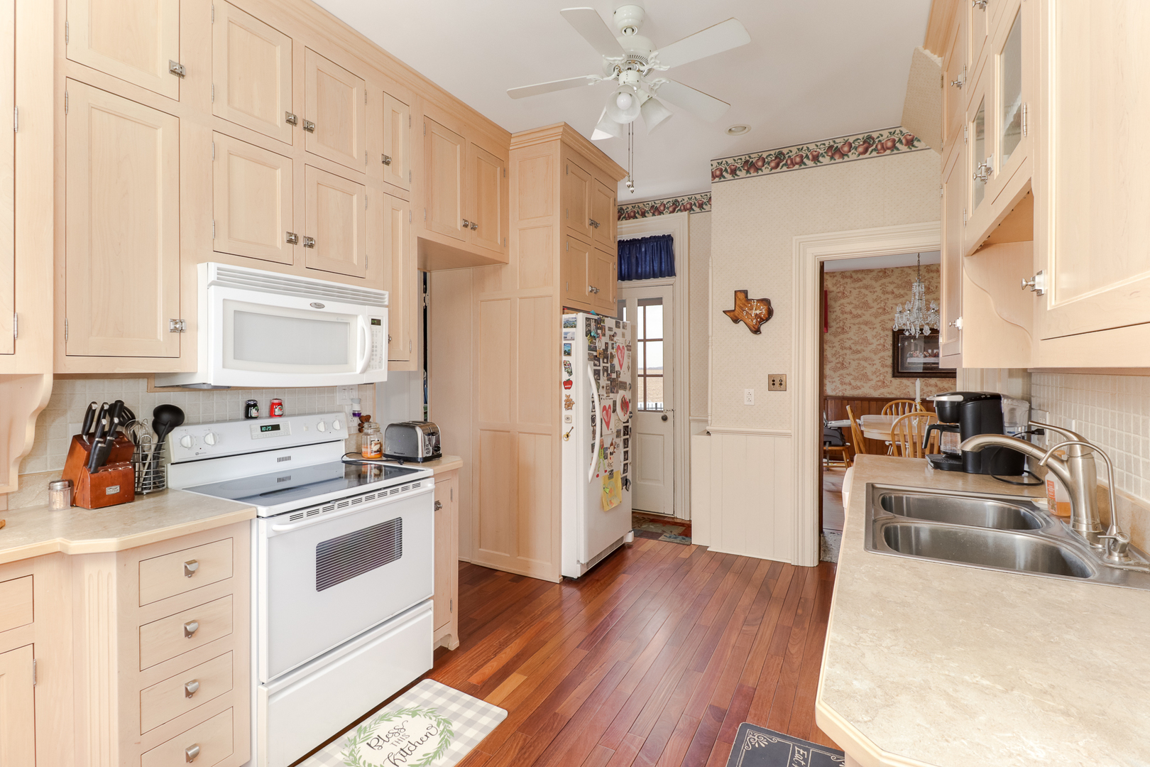 367 Horner Road Armington, IL 61721 - Photo 25 of 50 a kitchen with granite countertop a refrigerator a stove a sink dishwasher and white cabinets with wooden floor