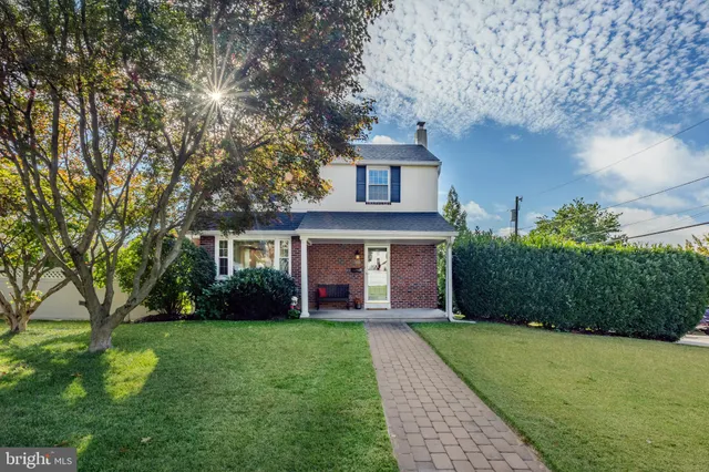a front view of a house with a garden and yard