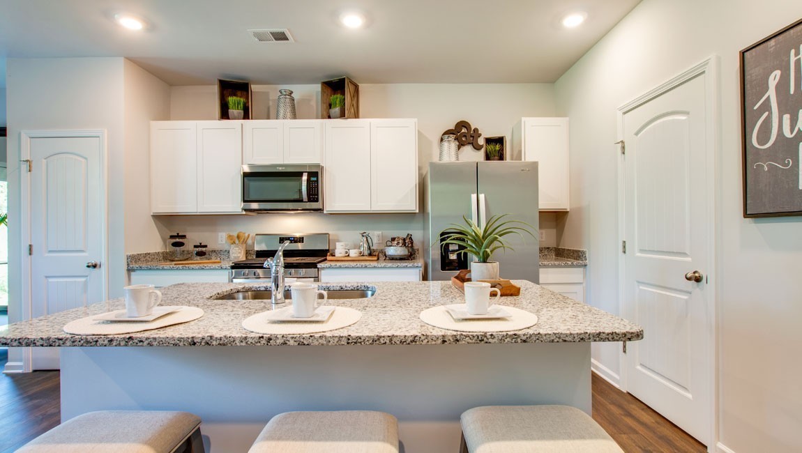 a kitchen with granite countertop a sink and a white stainless steel appliances