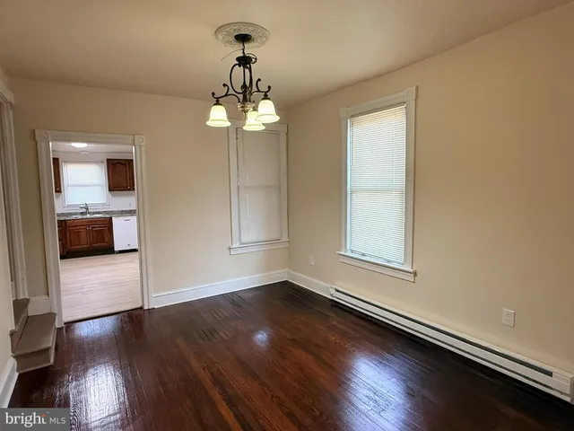 a view of a livingroom with wooden floor and a large window