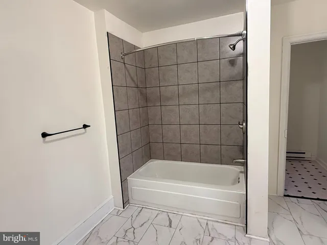 a bathroom with a bathtub and shower