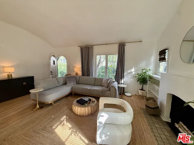 a kitchen with stainless steel appliances kitchen island granite countertop a refrigerator a stove a sink dishwasher and a refrigerator with wooden floor