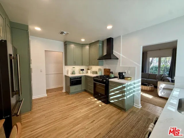 a kitchen with stainless steel appliances a stove a sink and a refrigerator