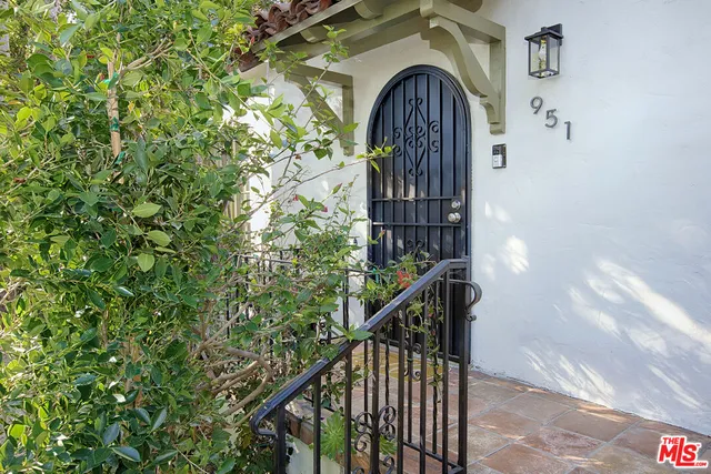 a front view of a house with plants