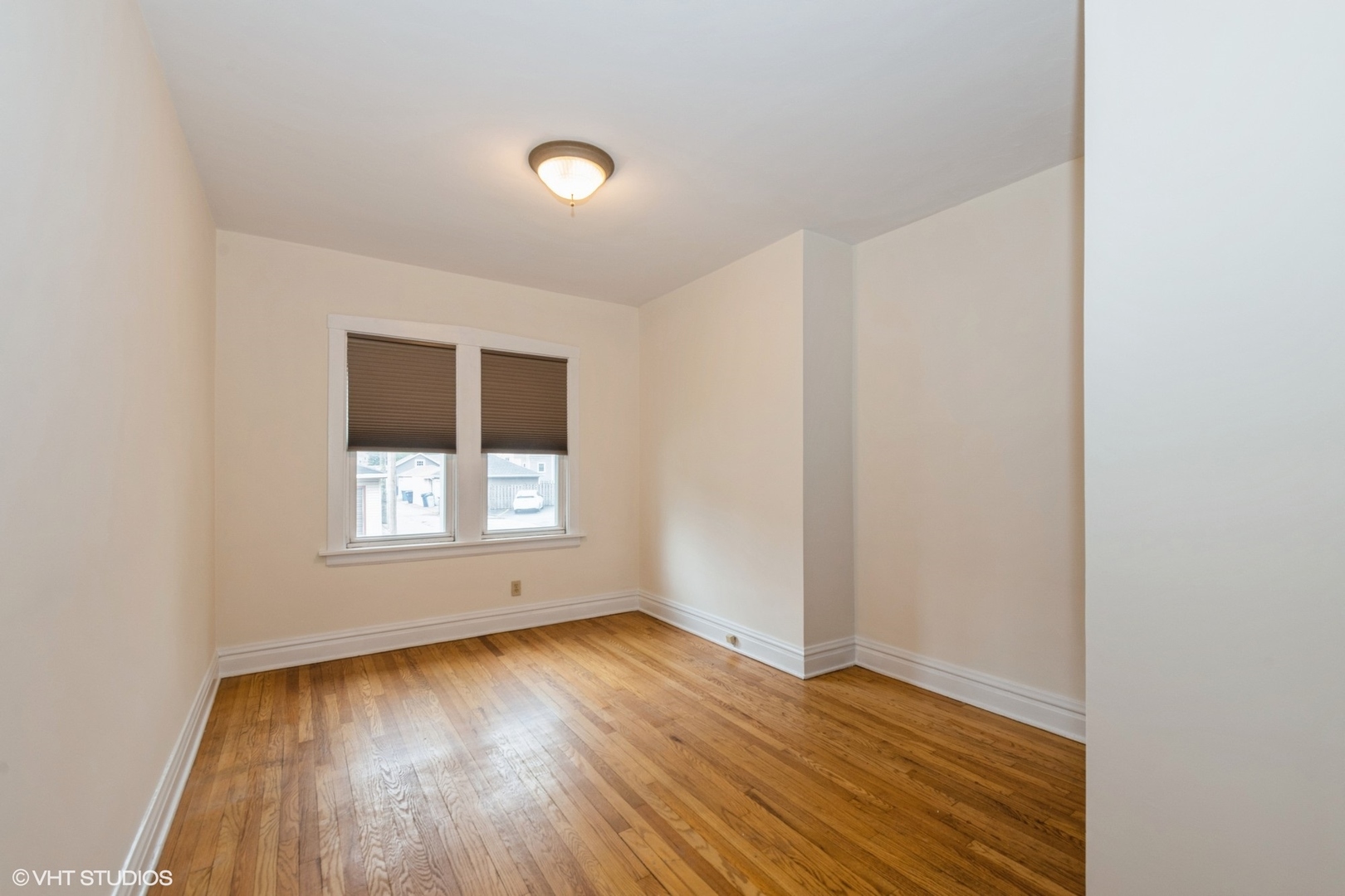 435 Jackson Boulevard Forest Park, IL 60130 - Photo 11 of 19 an empty room with wooden floor and windows