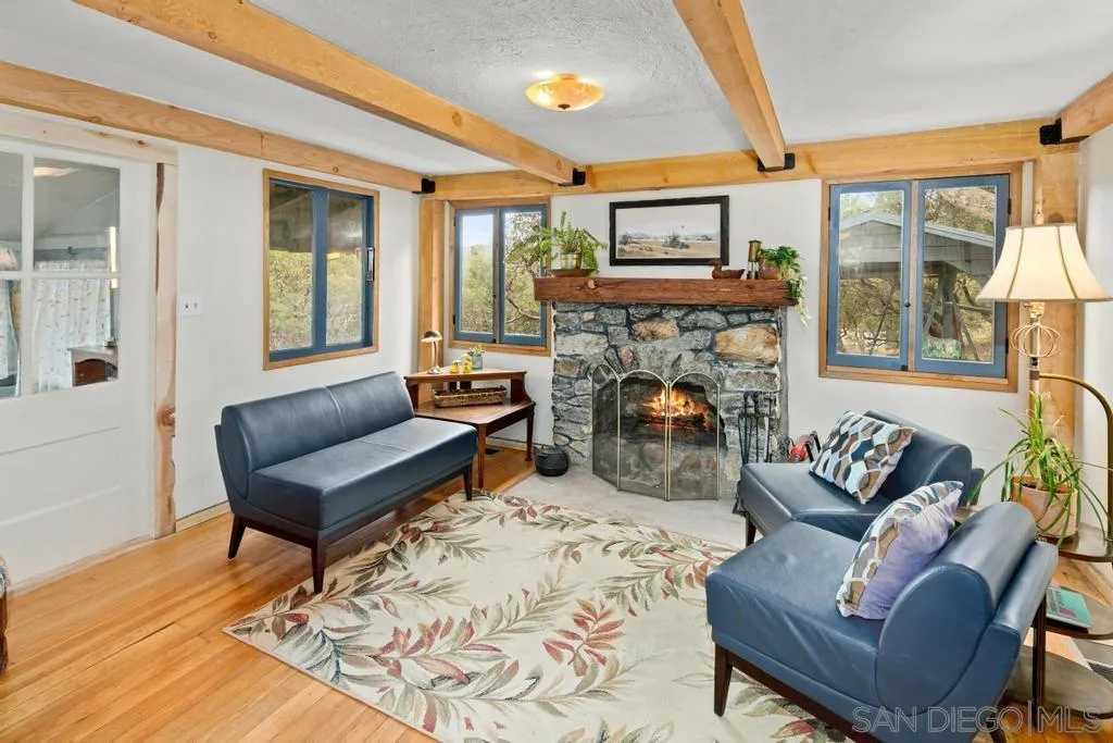 813 Pine Cone Drive Julian, CA 92036 - Photo 12 of 39 a living room with furniture fireplace and a large window