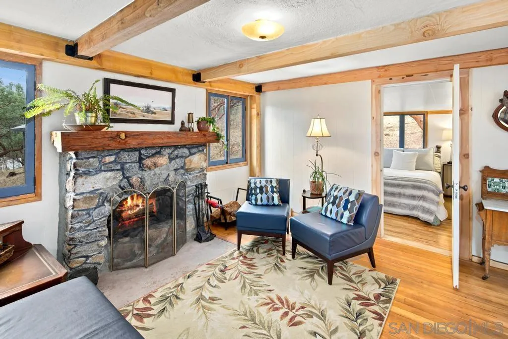813 Pine Cone Drive Julian, CA 92036 - Photo 14 of 39 a living room with furniture and a fireplace