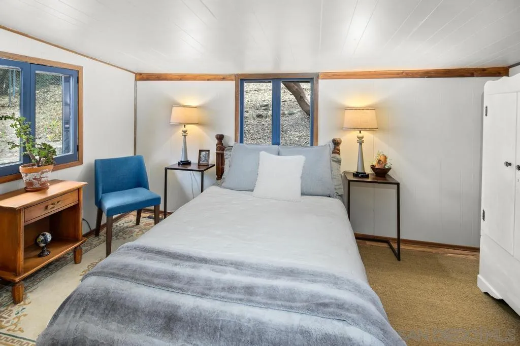 813 Pine Cone Drive Julian, CA 92036 - Photo 16 of 39 a bed room with a bed and a chair