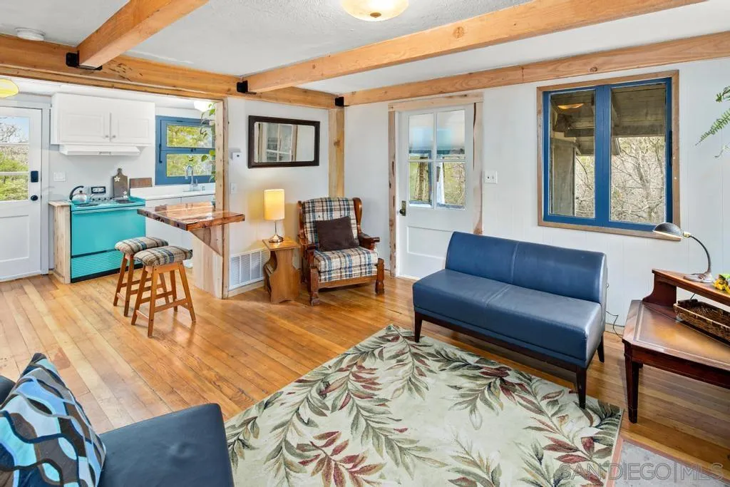 813 Pine Cone Drive Julian, CA 92036 - Photo 20 of 39 a living room with furniture wooden floor and a table