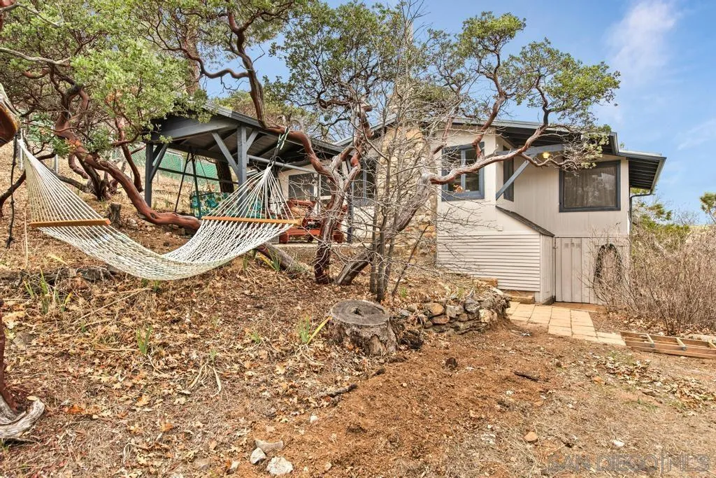 813 Pine Cone Drive Julian, CA 92036 - Photo 25 of 39 a backyard of a house with table and chairs