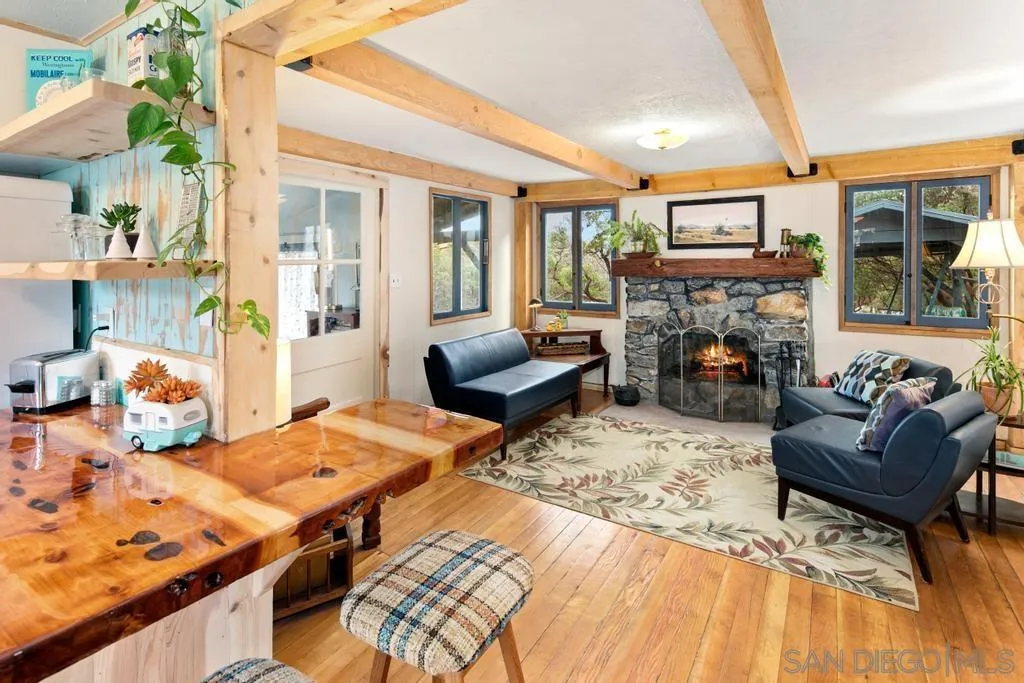 813 Pine Cone Drive Julian, CA 92036 - Photo 6 of 39 a living room with furniture fireplace and a table