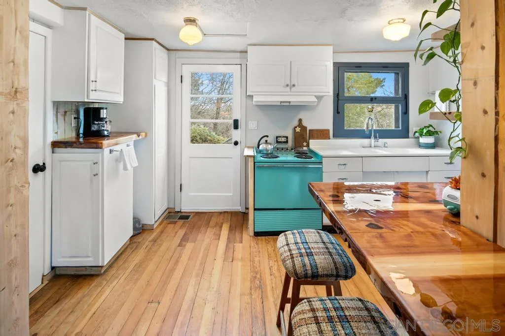 813 Pine Cone Drive Julian, CA 92036 - Photo 7 of 39 a kitchen with wooden floors and appliances