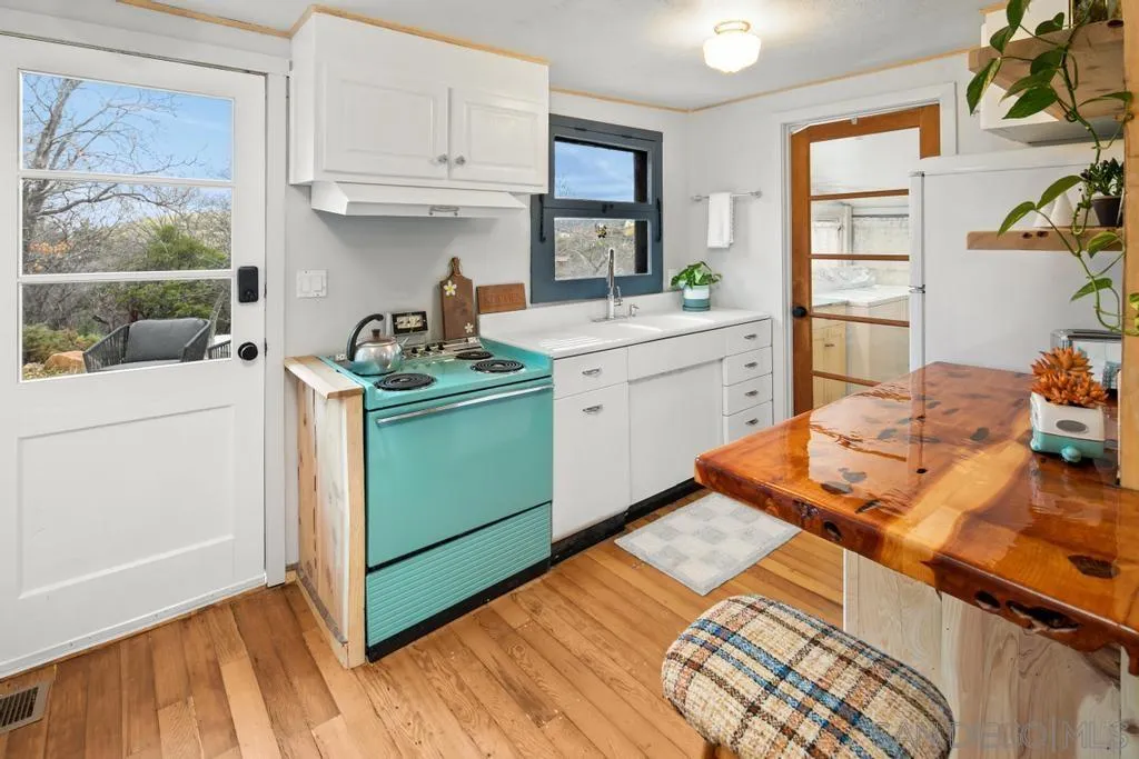 813 Pine Cone Drive Julian, CA 92036 - Photo 8 of 39 a kitchen with a sink and cabinets