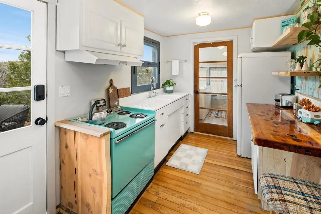 813 Pine Cone Drive Julian, CA 92036 - Photo 9 of 39 a kitchen with a stove and a refrigerator