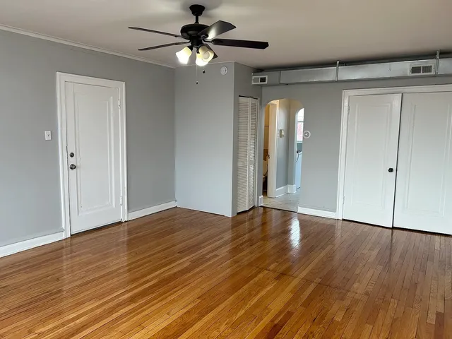 a kitchen with white cabinets and sink