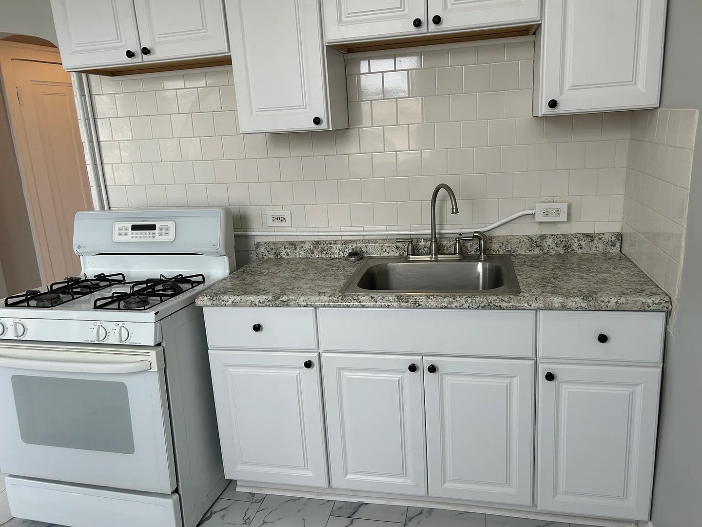 5701 West Roosevelt Road Cicero, IL 60804 - Photo 24 of 32 a kitchen with white cabinets and sink