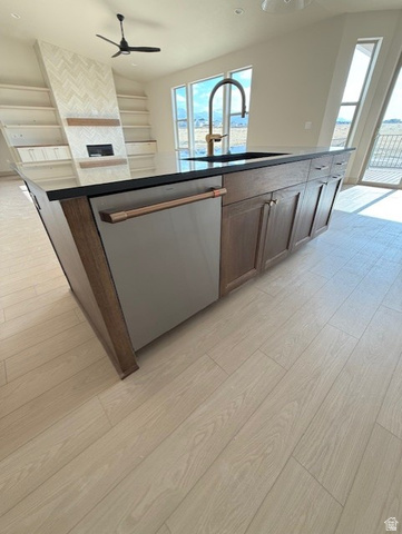 533 West S Temple Street, Unit 309 Tooele, UT 84074 - Photo 5 of 24 Kitchen with light wood-type flooring, stainless steel dishwasher, an island with sink, dark countertops, and recessed lighting