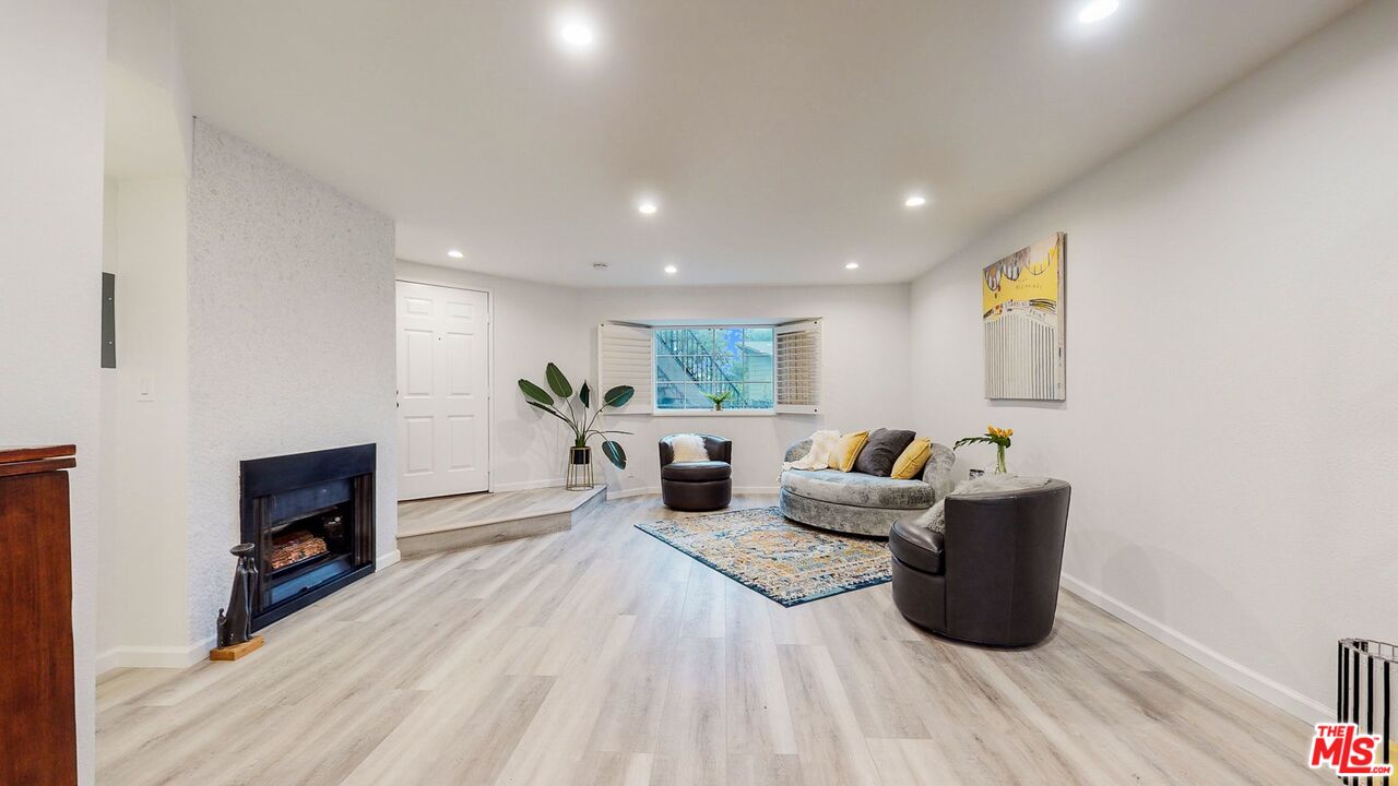 246 Alpine Street, Unit 15 Pasadena, CA 91106 - Photo 2 of 16 a living room with furniture a flat screen tv and a wooden floor