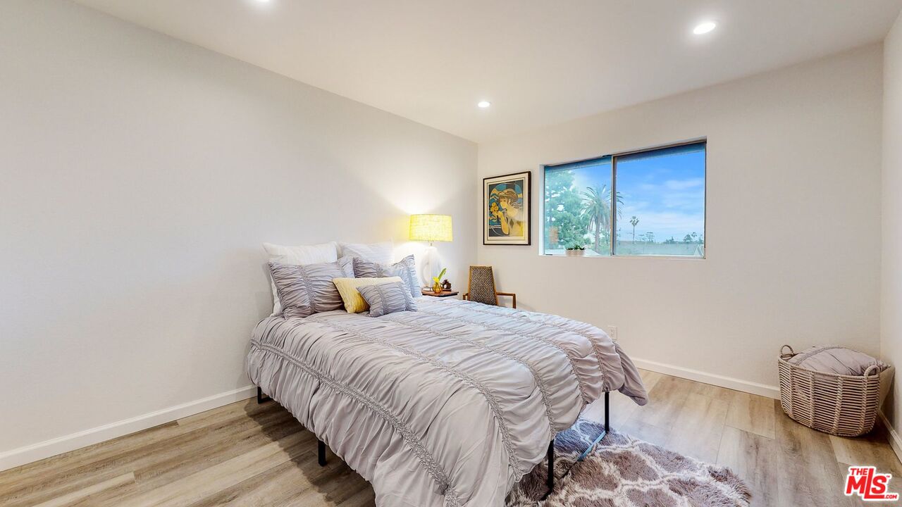 246 Alpine Street, Unit 15 Pasadena, CA 91106 - Photo 11 of 16 a bedroom with a bed and wooden floor