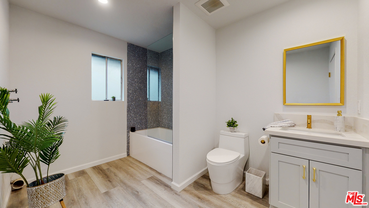 246 Alpine Street, Unit 15 Pasadena, CA 91106 - Photo 12 of 16 a bathroom with a toilet a sink and a mirror