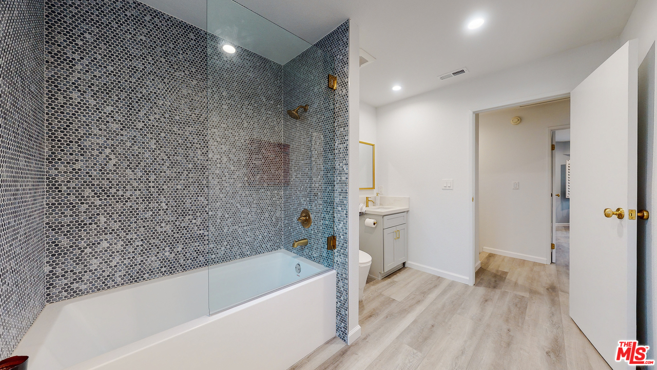 246 Alpine Street, Unit 15 Pasadena, CA 91106 - Photo 13 of 16 a bathroom with a bathtub and a shower