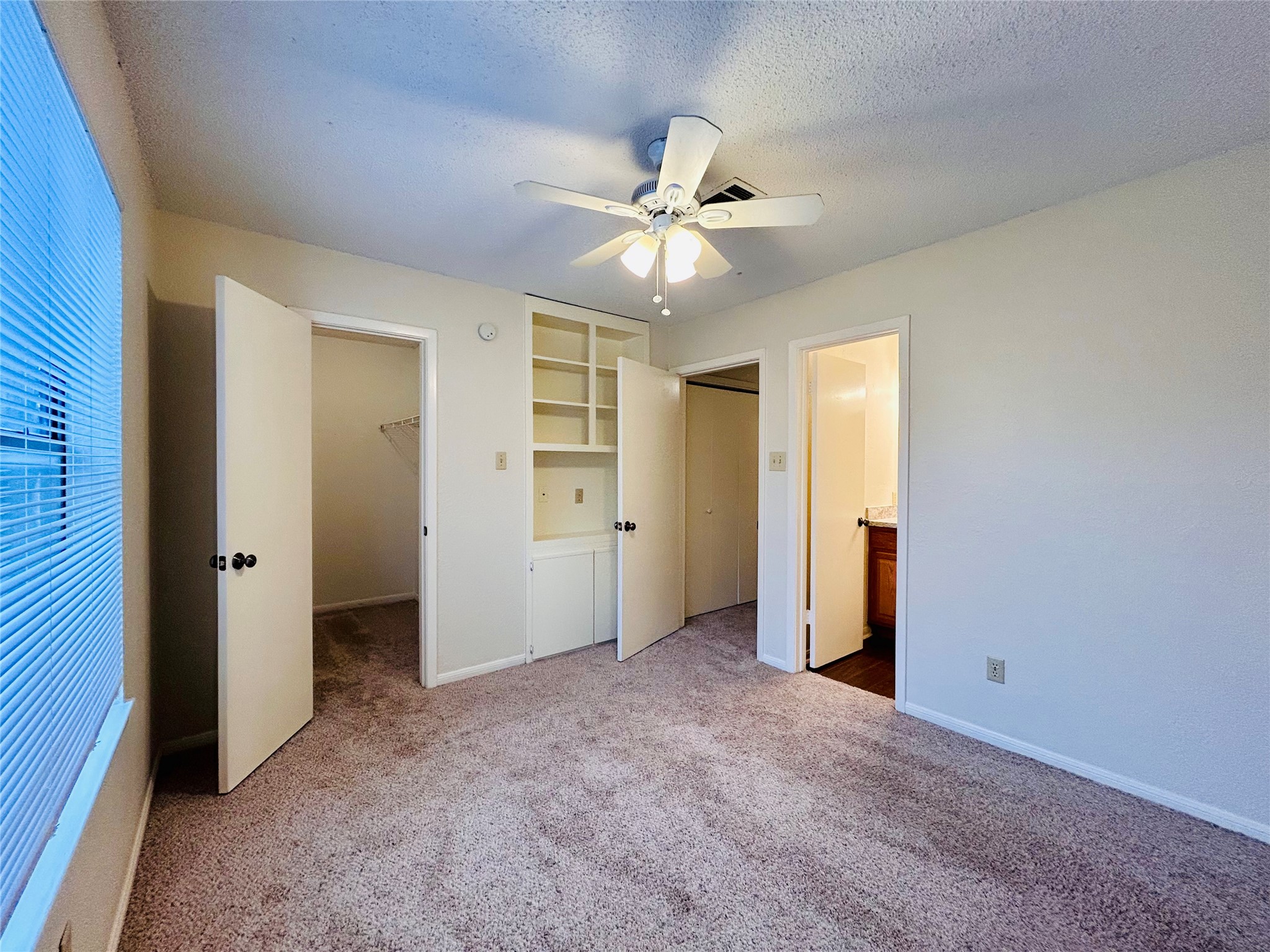 8902 Schick Road, Unit B Austin, TX 78729 - Photo 11 of 20 an empty room with closet and a ceiling fan