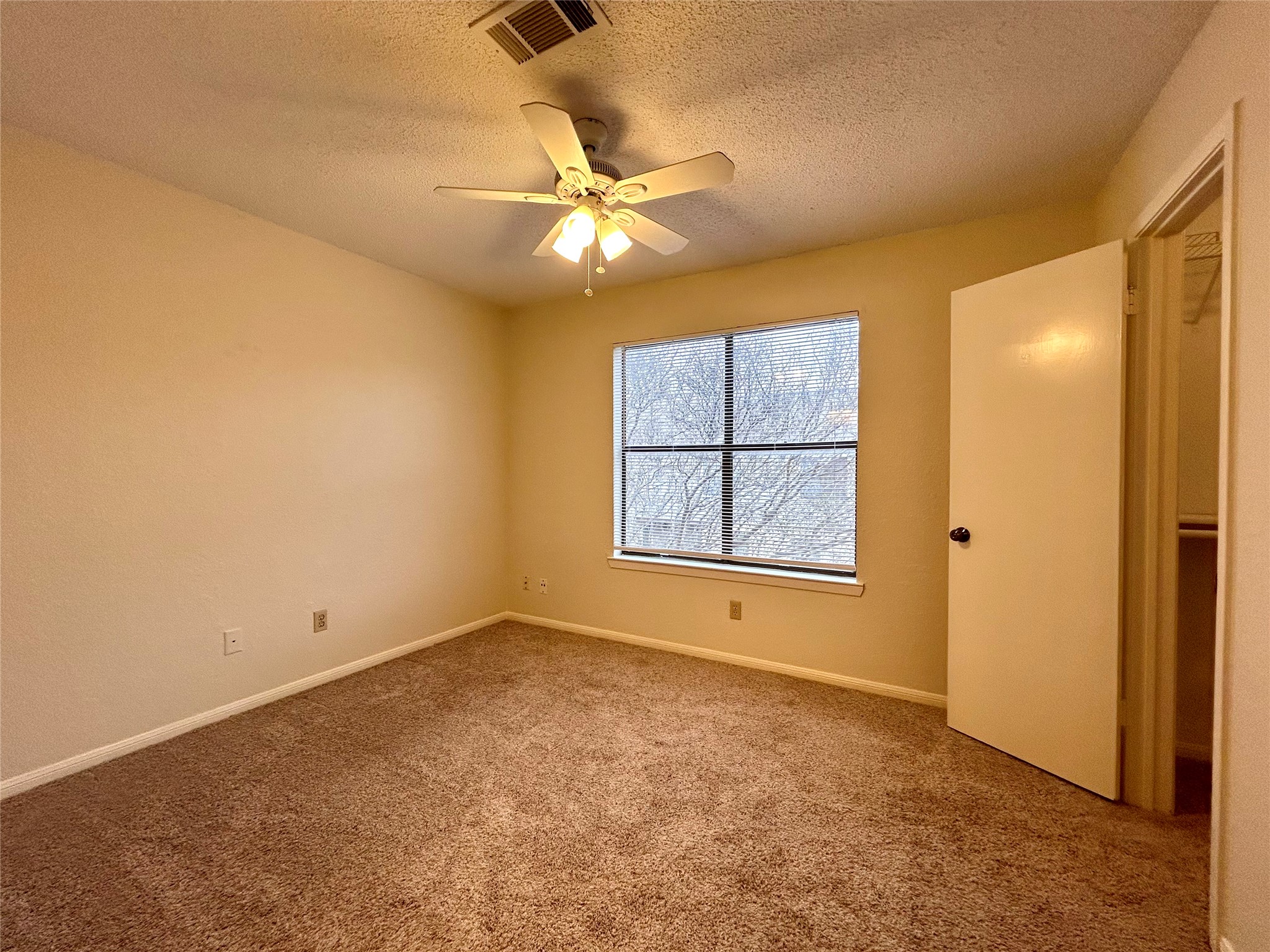 8902 Schick Road, Unit B Austin, TX 78729 - Photo 13 of 20 an empty room with windows and fan
