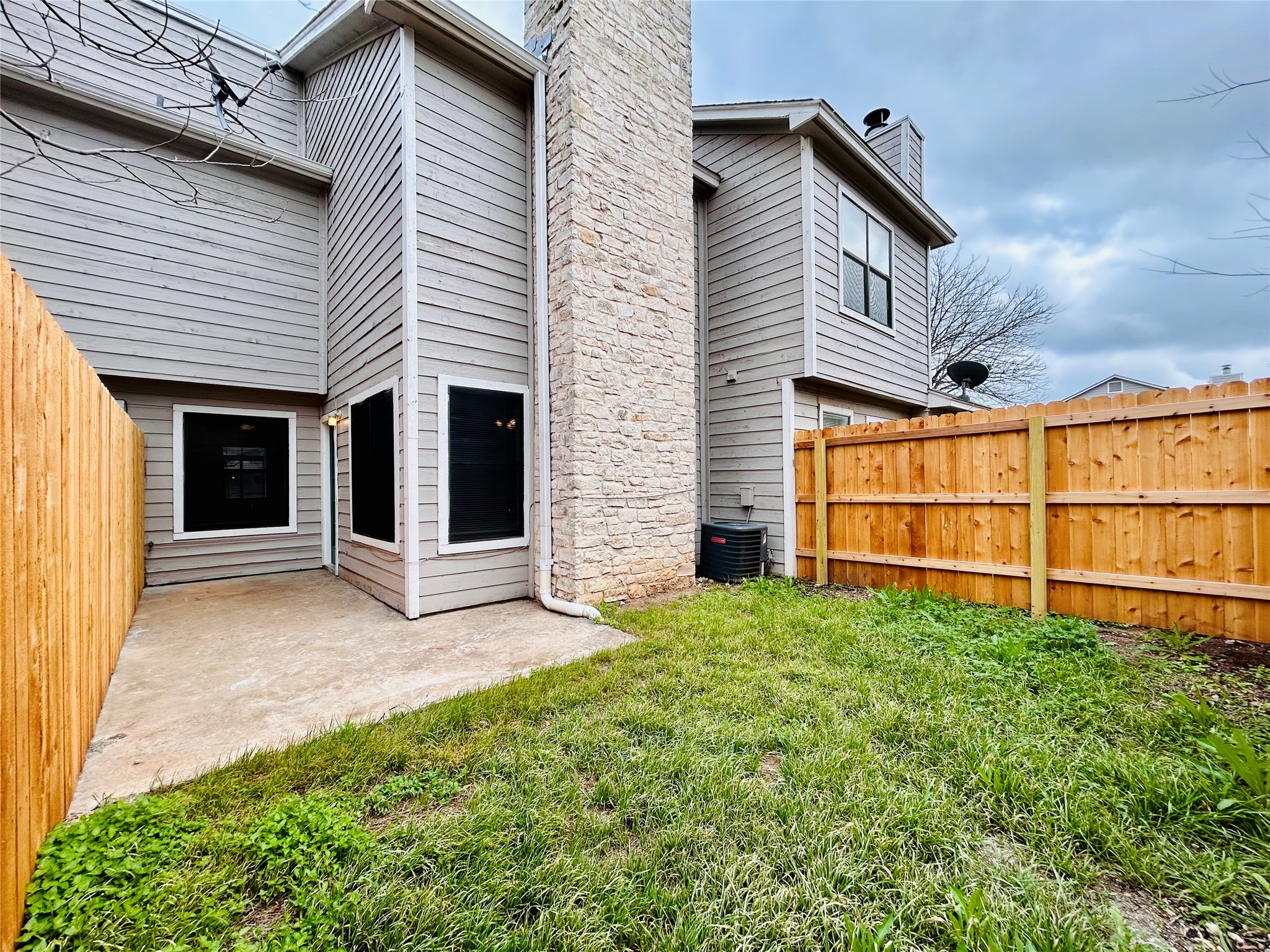 8902 Schick Road, Unit B Austin, TX 78729 - Photo 19 of 20 a view of a house with a yard and garage