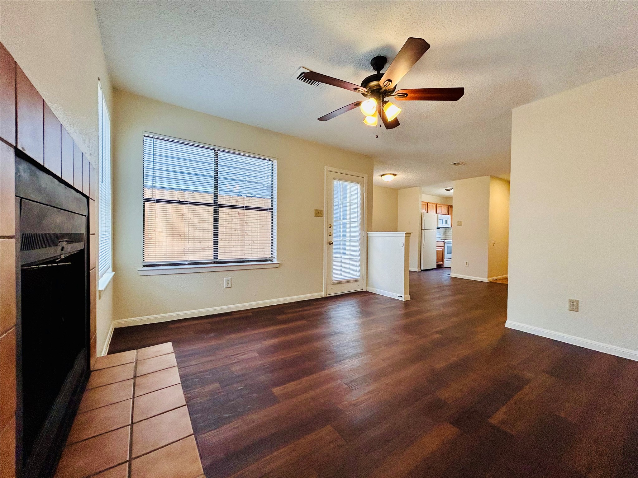 8902 Schick Road, Unit B Austin, TX 78729 - Photo 3 of 20 a view of an empty room with a window and wooden floor