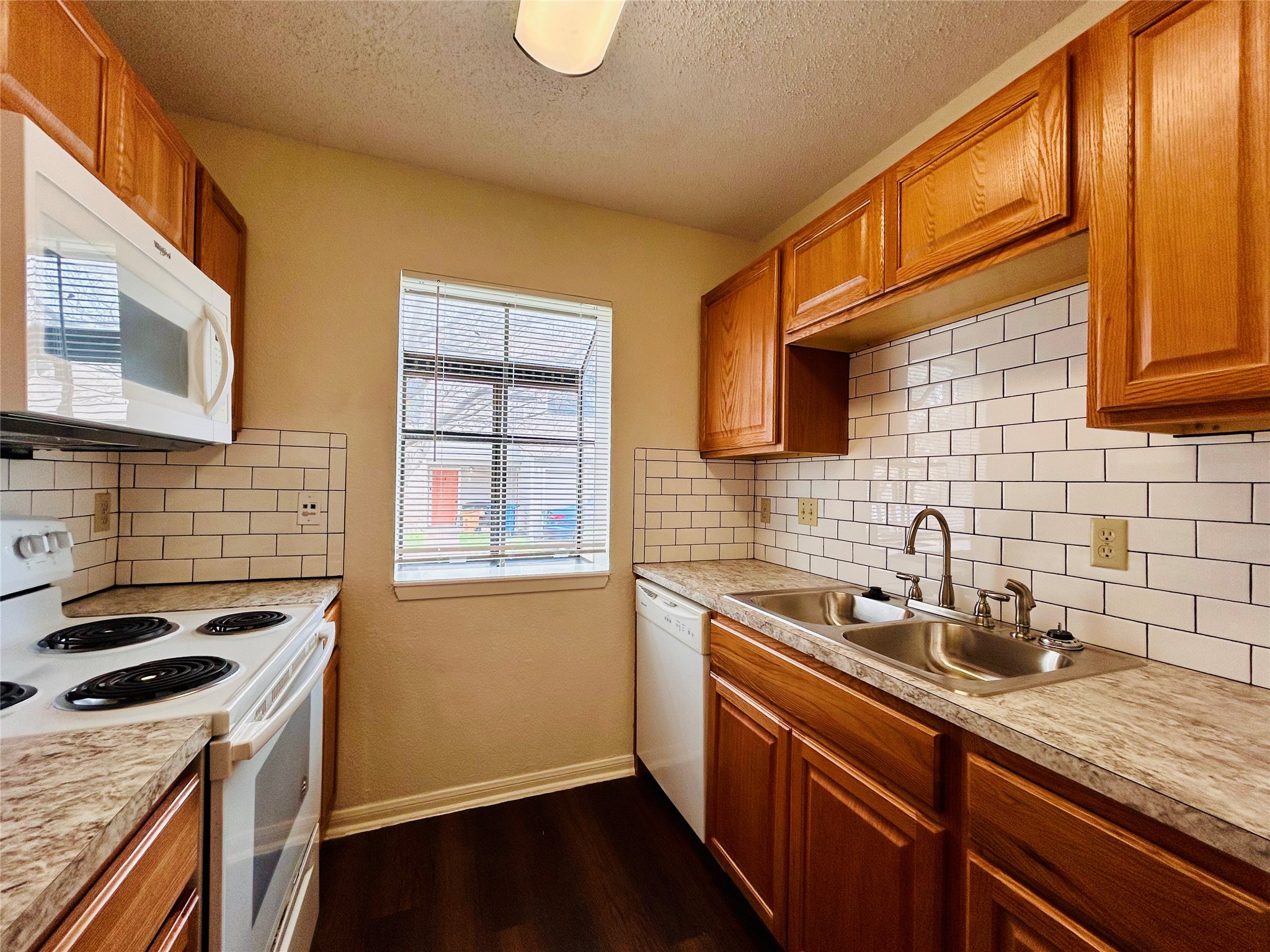 8902 Schick Road, Unit B Austin, TX 78729 - Photo 5 of 20 a kitchen that has a sink and a stove