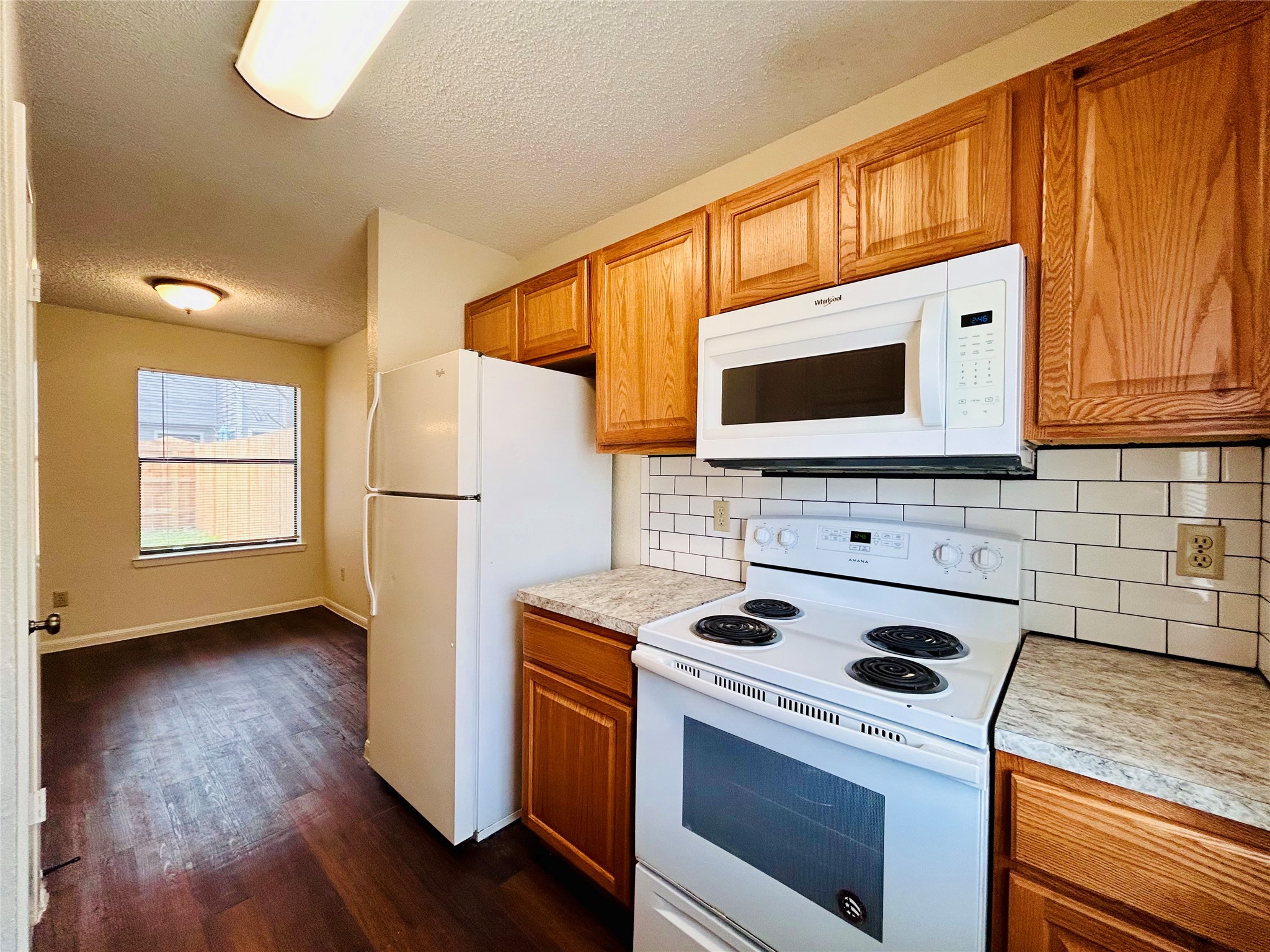 8902 Schick Road, Unit B Austin, TX 78729 - Photo 6 of 20 a kitchen with a microwave a stove a sink and a microwave