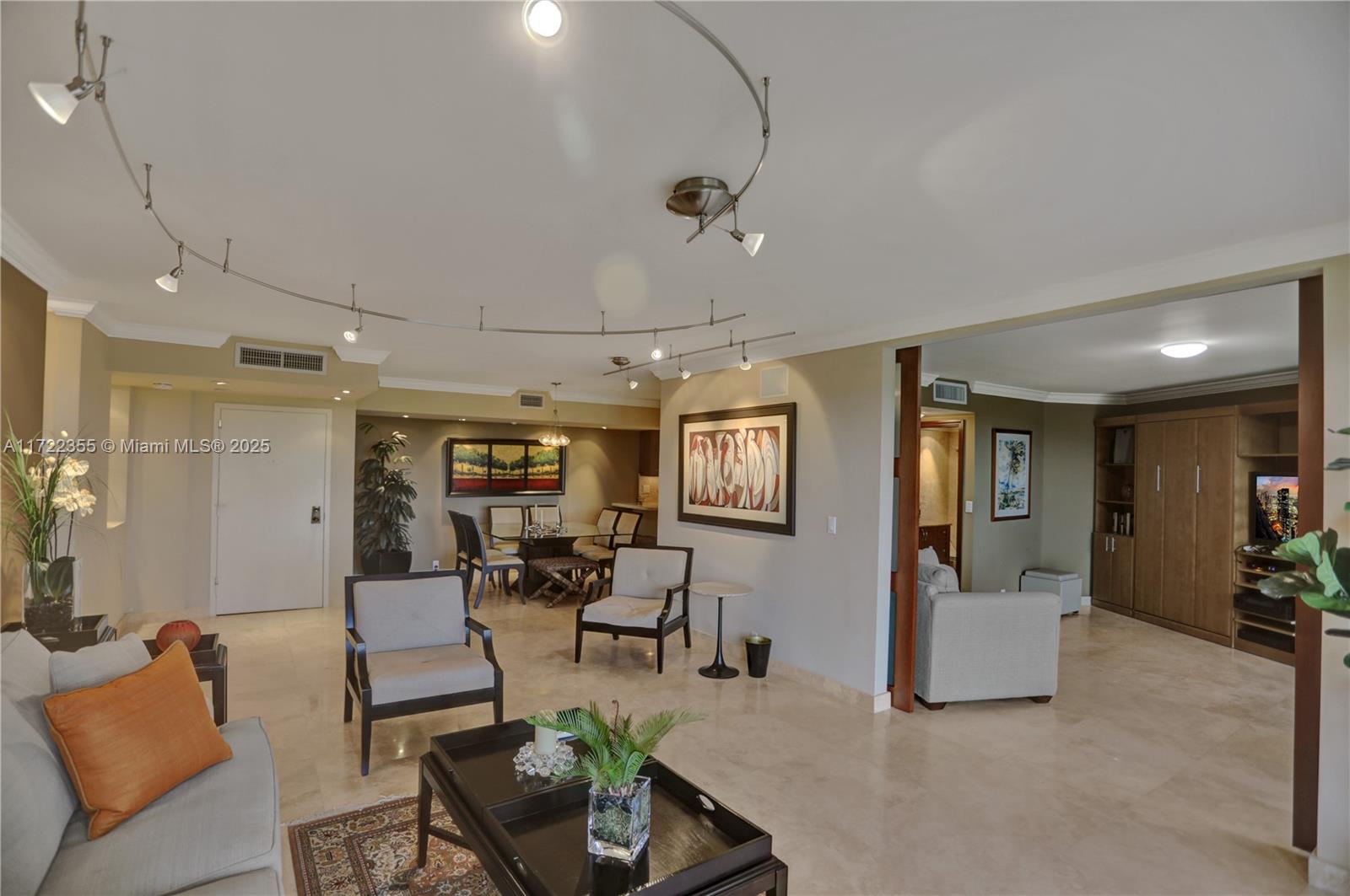 1121 Crandon Boulevard, Unit E405 Key Biscayne, FL 33149 - Photo 1 of 32 a living room with furniture and wooden floor