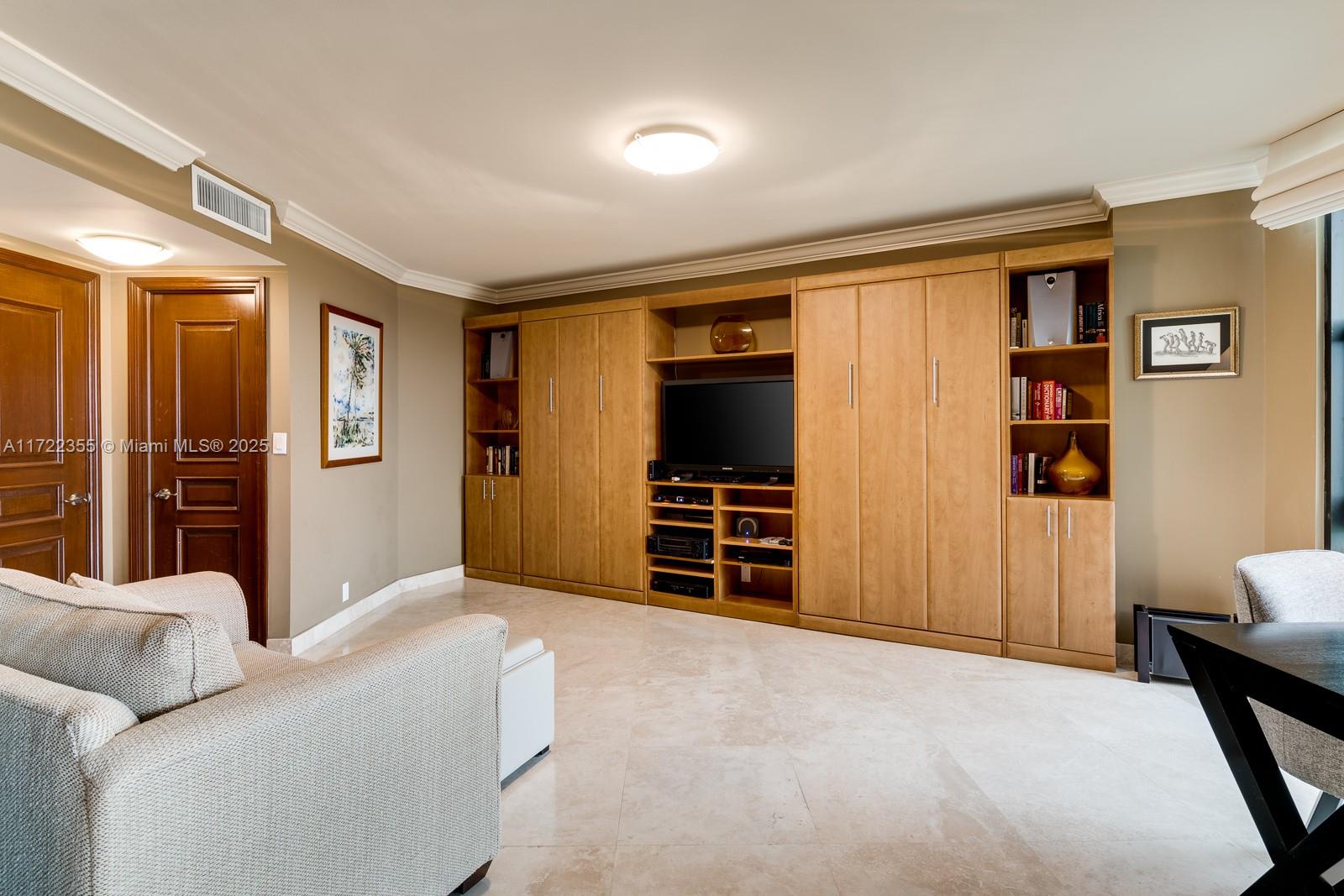 1121 Crandon Boulevard, Unit E405 Key Biscayne, FL 33149 - Photo 13 of 32 a living room with furniture and a flat screen tv
