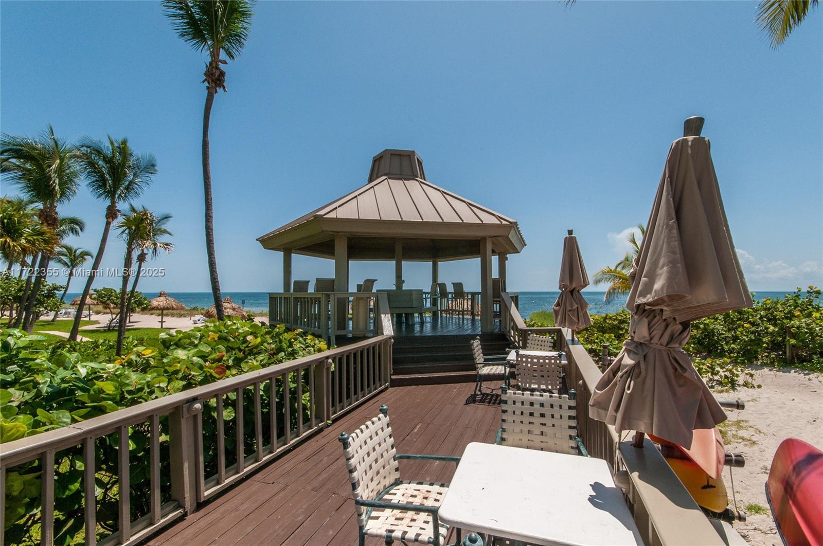 1121 Crandon Boulevard, Unit E405 Key Biscayne, FL 33149 - Photo 22 of 32 a view of a patio with table and chairs potted plants